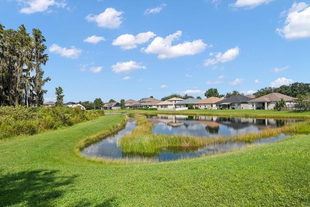 view of property's community with a water view and a yard