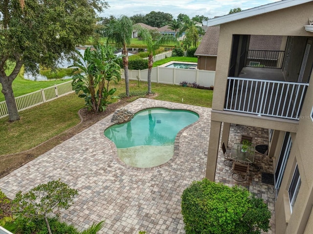 view of pool featuring a patio and a yard