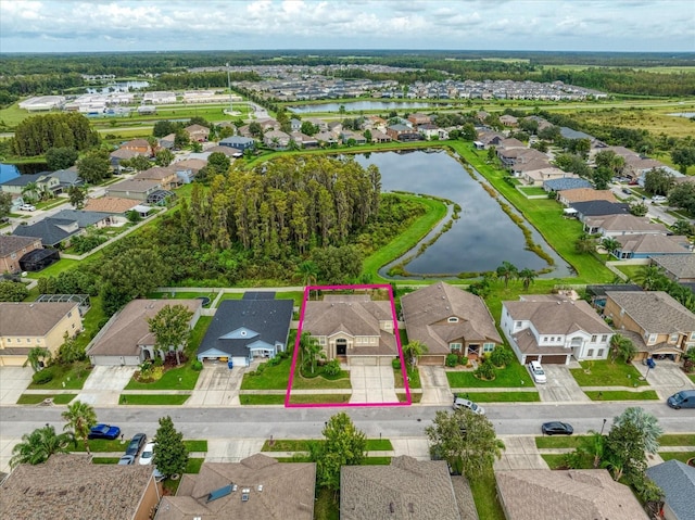 birds eye view of property with a water view and a residential view