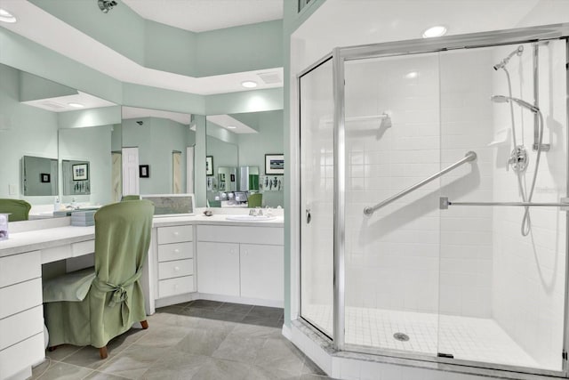 bathroom featuring vanity, tile patterned floors, and walk in shower