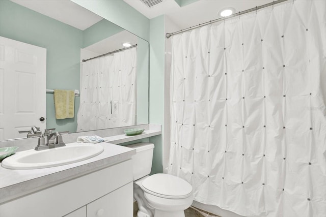 bathroom featuring vanity, a shower with shower curtain, and toilet