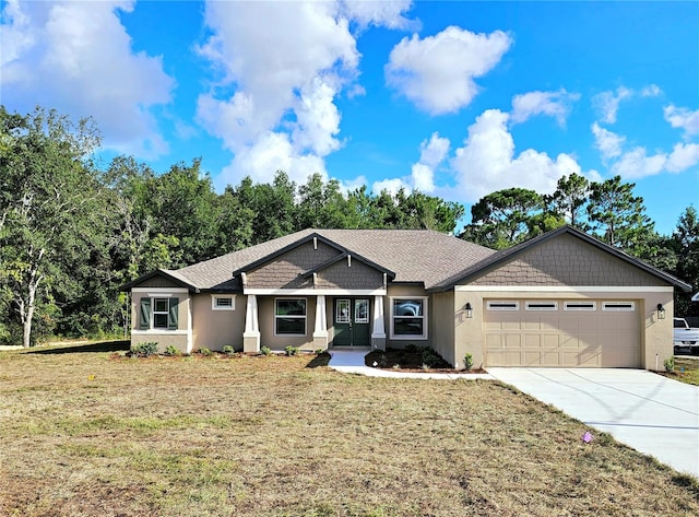 view of front facade with a front yard and a garage