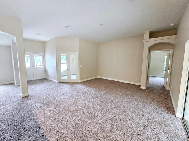 carpeted empty room featuring french doors