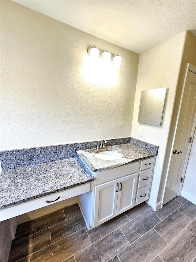 bathroom featuring vanity and a textured ceiling