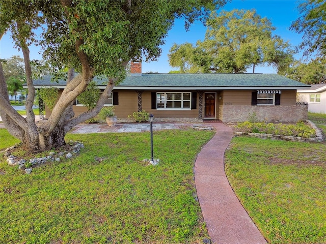 1756 Ashton Abbey Rd, Clearwater, FL 33755 - ranch-style home with a chimney and a front lawn