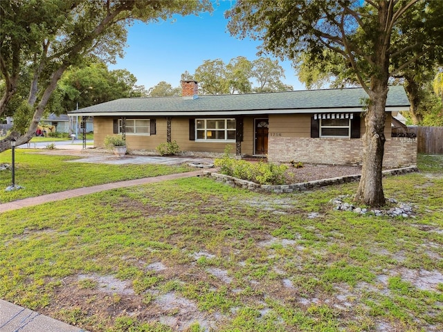 ranch-style home featuring a front yard