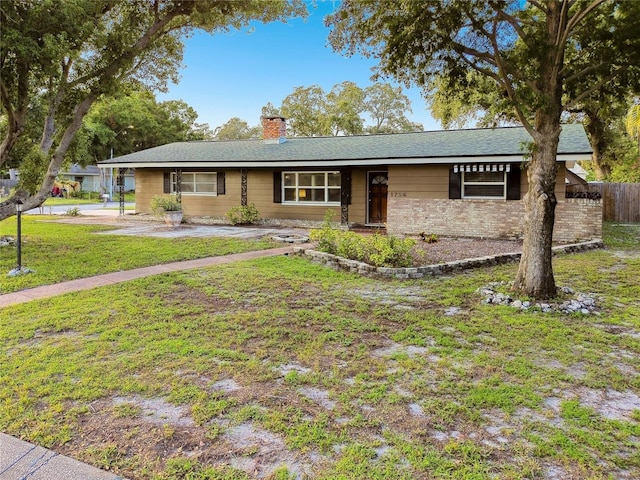 1756 Ashton Abbey Rd, Clearwater, FL 33755 - ranch-style house with a chimney, fence, and a front yard