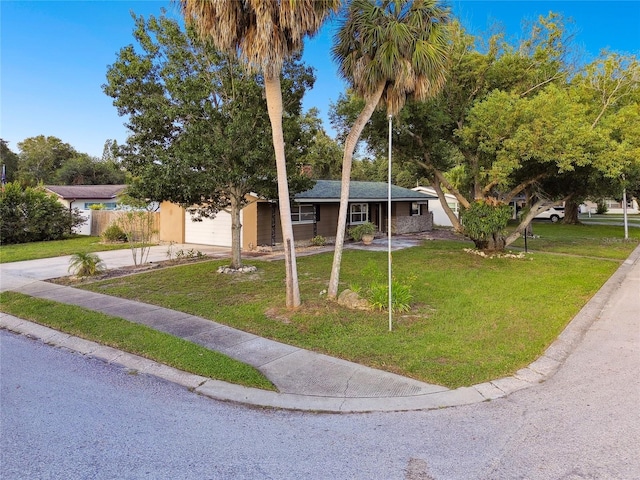 view of front of property with a front lawn and a garage