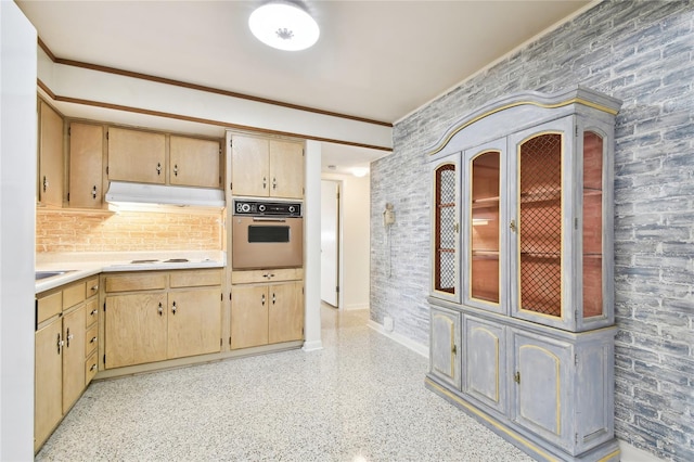 kitchen featuring light brown cabinets, sink, white cooktop, and stainless steel oven