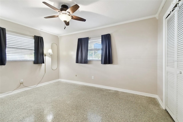 unfurnished bedroom with crown molding, ceiling fan, and a closet