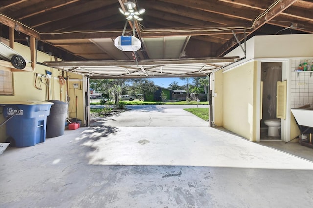 garage with a garage door opener and a carport