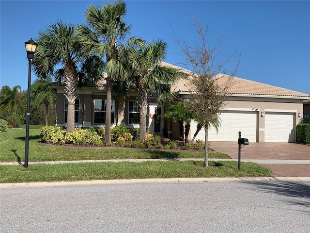 view of front of property featuring a garage and a front yard