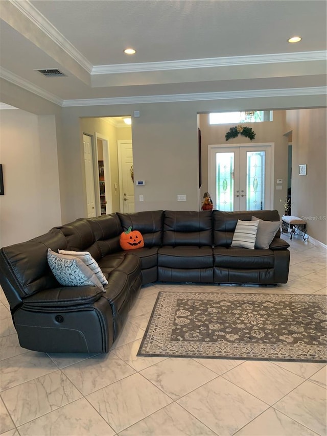 living room with crown molding, french doors, and a raised ceiling