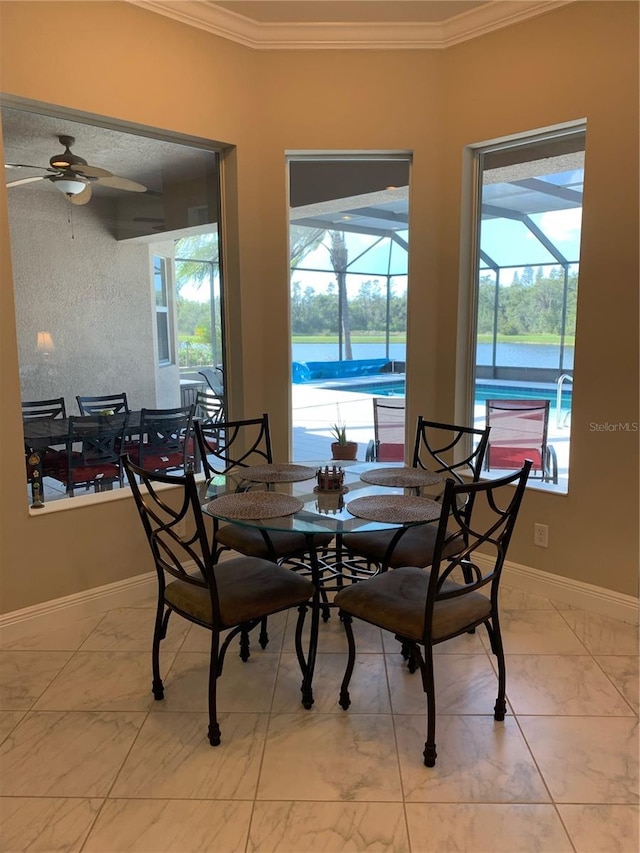 dining area featuring crown molding, ceiling fan, and a healthy amount of sunlight