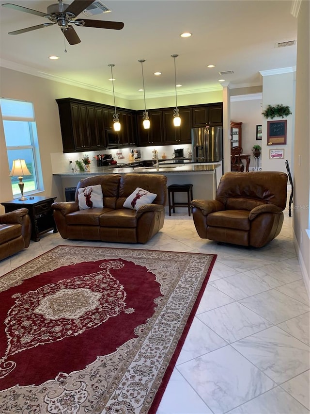 living room with crown molding and ceiling fan