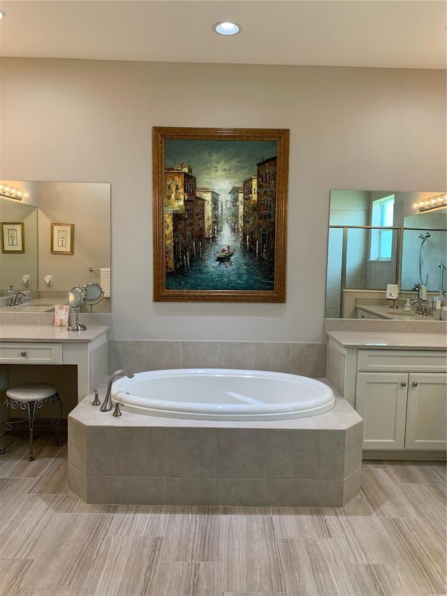 bathroom with vanity and separate shower and tub