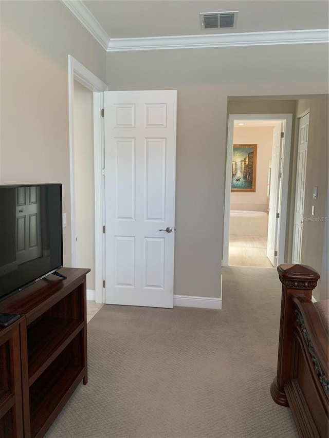 interior space featuring light carpet and ornamental molding