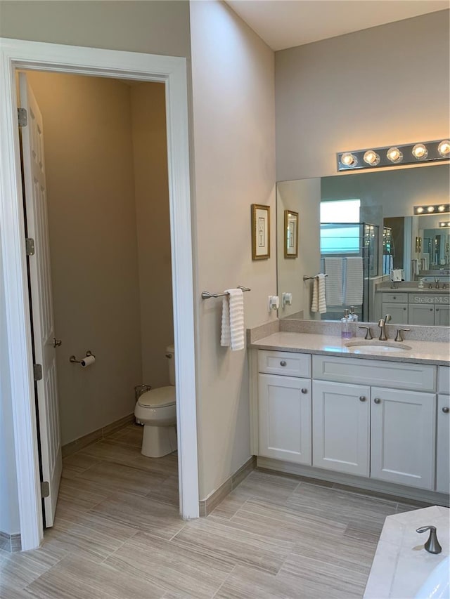 bathroom featuring vanity and toilet