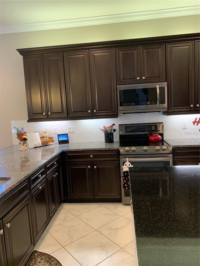 kitchen with crown molding, dark brown cabinetry, and stainless steel appliances