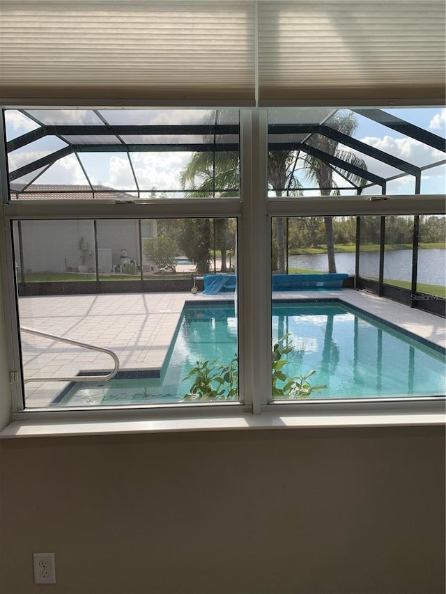 view of pool featuring a water view