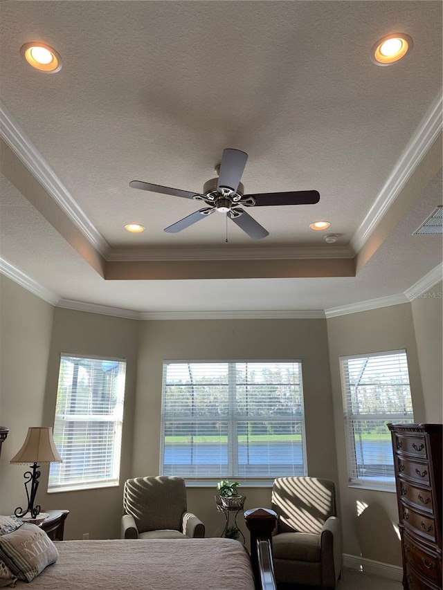bedroom featuring ceiling fan, crown molding, a raised ceiling, and a textured ceiling