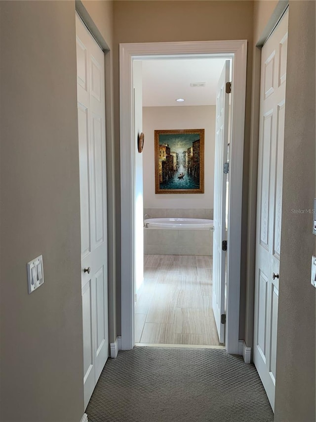 hall featuring carpet