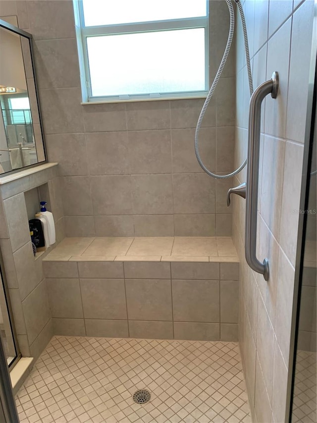 bathroom with a tile shower