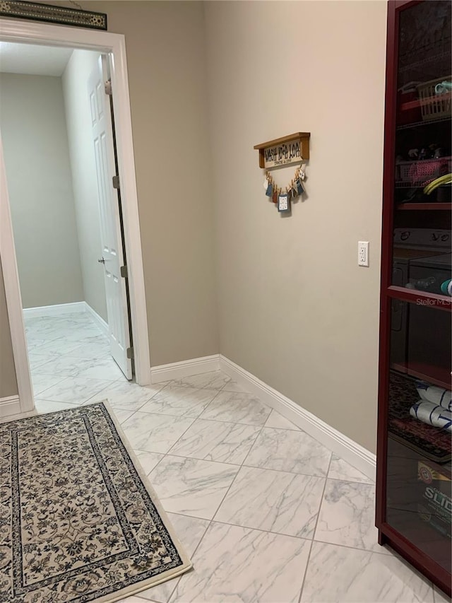 corridor featuring washer / clothes dryer