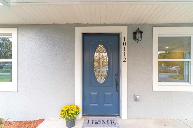 view of exterior entry with a porch