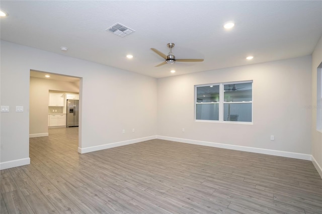 empty room featuring light hardwood / wood-style flooring and ceiling fan