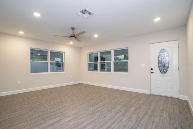 foyer entrance with hardwood / wood-style floors and ceiling fan