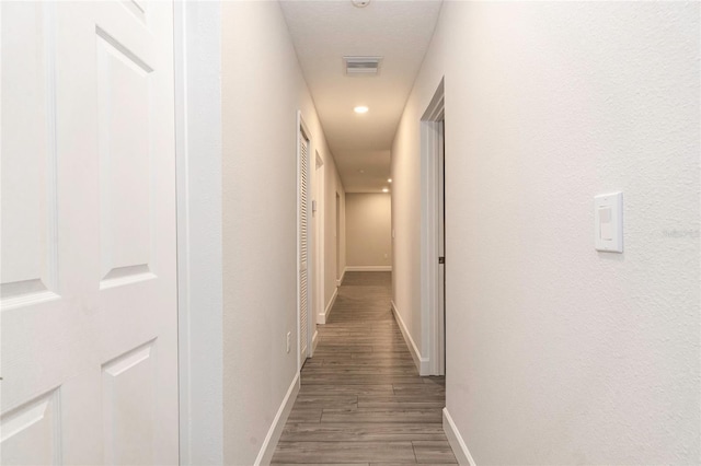 hallway with dark hardwood / wood-style flooring