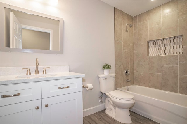 full bathroom featuring toilet, tiled shower / bath combo, vanity, and wood-type flooring