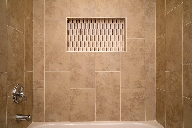 interior details with tiled shower / bath