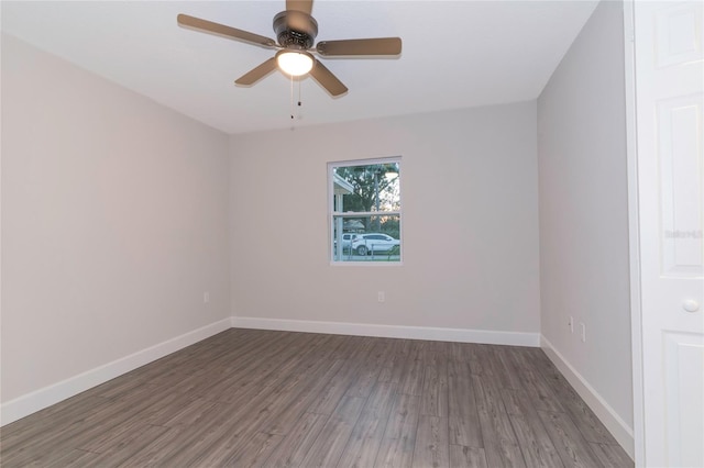 spare room featuring ceiling fan and dark hardwood / wood-style floors