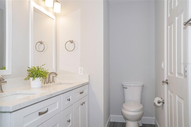 bathroom with toilet and vanity