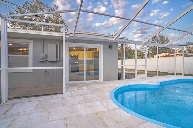 view of swimming pool with a patio and glass enclosure