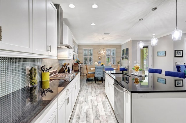 kitchen featuring white cabinets, sink, decorative light fixtures, dishwasher, and crown molding