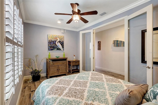 bedroom featuring crown molding, ceiling fan, and hardwood / wood-style flooring