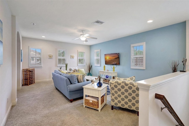 carpeted living room with ceiling fan