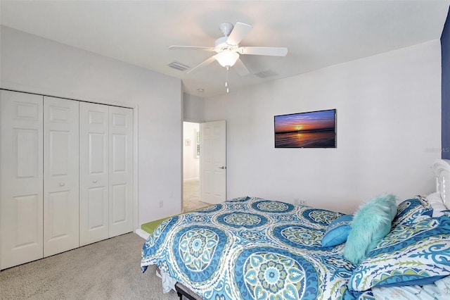 bedroom featuring light carpet, ceiling fan, and a closet