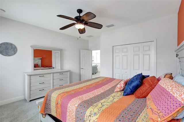 bedroom with ceiling fan, a closet, and light carpet