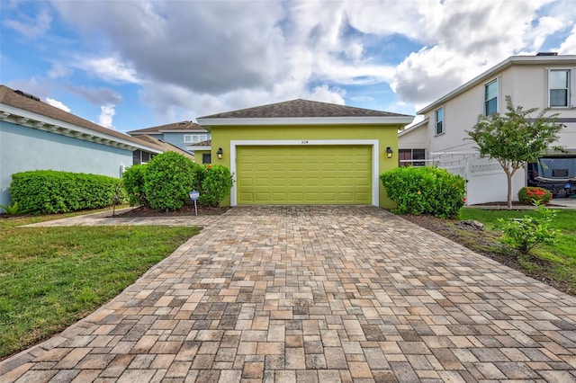 view of front of house featuring a front yard and a garage