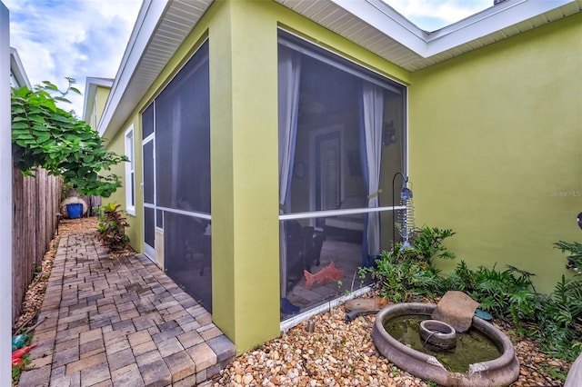 view of side of property featuring a sunroom