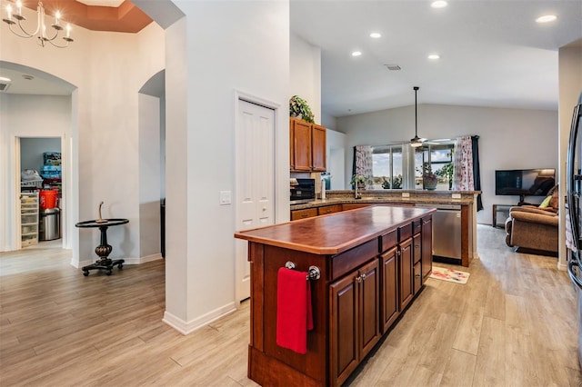 kitchen with sink, a kitchen island, light hardwood / wood-style flooring, dishwasher, and vaulted ceiling