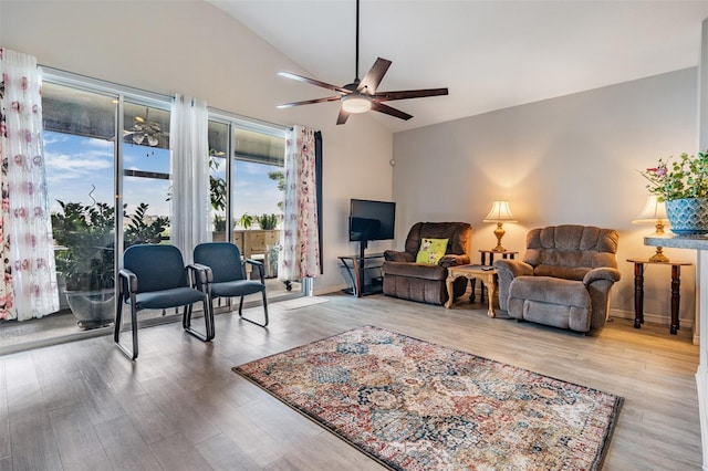 living room with light wood-type flooring, vaulted ceiling, and ceiling fan