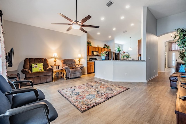 living room featuring light wood-type flooring and ceiling fan