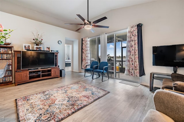 living room featuring vaulted ceiling, ceiling fan, and hardwood / wood-style flooring