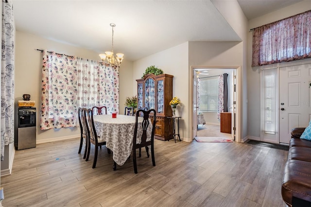 dining area with a chandelier and light hardwood / wood-style floors