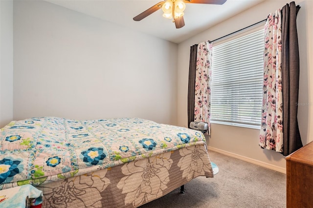 bedroom featuring multiple windows, carpet, and ceiling fan